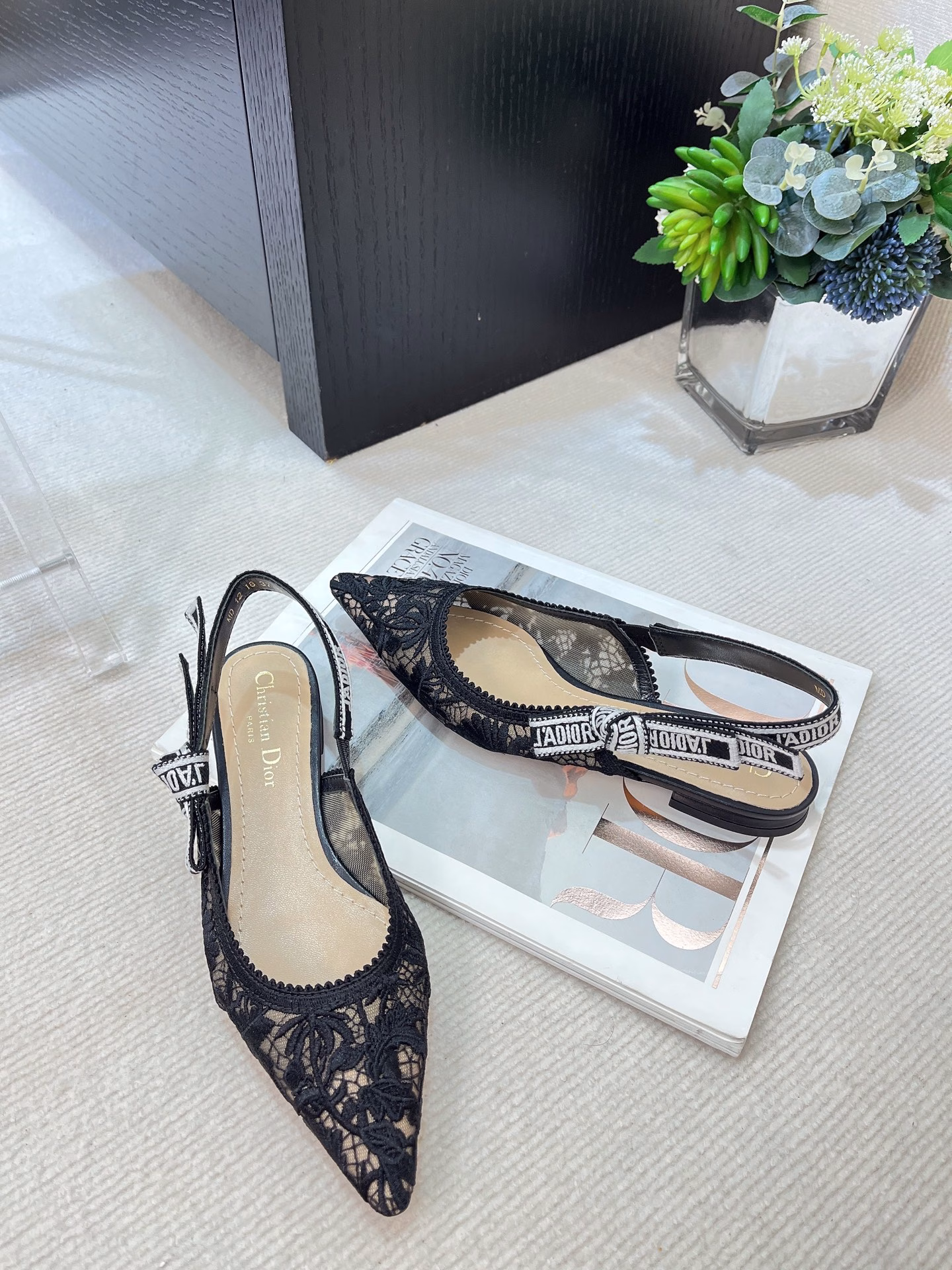 ✨The J’Adior slingback pump is a perfect example of Dior’s savoir-faire. Crafted in the Italian workshops of Christian Dior, it is crafted from materials such as transparent mesh and embroidered with the Dior Chardons motif designed by Pietro Ruffo in black cotton thread, showing the Scottish national flower, which symbolizes protection, resilience and freedom. The J’Adior two-tone embroidered band is embellished with a flat bow and is paired with a 1.0 cm, 6.5 cm and 10 cm comma heel for an elegant and sophisticated look. Pair with other pieces from the Dior Chardons collection.