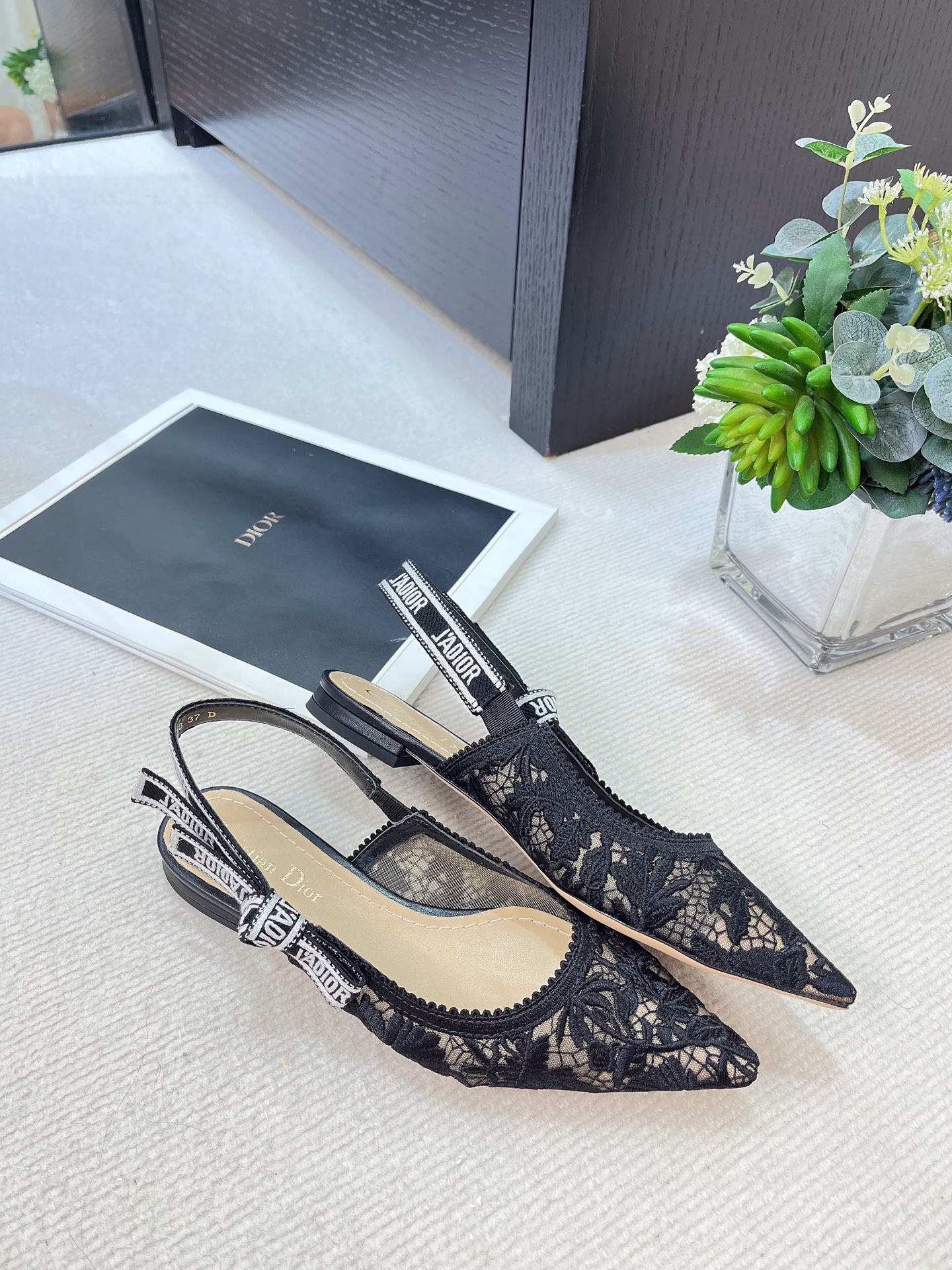 ✨The J’Adior slingback pump is a perfect example of Dior’s savoir-faire. Crafted in the Italian workshops of Christian Dior, it is crafted from materials such as transparent mesh and embroidered with the Dior Chardons motif designed by Pietro Ruffo in black cotton thread, showing the Scottish national flower, which symbolizes protection, resilience and freedom. The J’Adior two-tone embroidered band is embellished with a flat bow and is paired with a 1.0 cm, 6.5 cm and 10 cm comma heel for an elegant and sophisticated look. Pair with other pieces from the Dior Chardons collection.