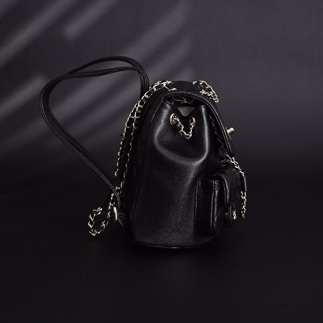 Chanel Duma 24A Retro Light Gold Buckle Diamond PatternLychee Pattern Cowhide - Backpack Medium - Unisex Couple Style Black! I fell in love with this bag at first sight! I love this luxury and low-key, fashionable and practical. In every detail, it reveals a unique artistic charm and design concept. At first glance, the design of this backpack is simple and atmospheric, but unique design elements are injected into every corner, which makes people stop and appreciate it. …Its capacity is large enough to hold, but it will not look bulky, so that you can meet your daily needs while pursuing fashion. Whether it is work or leisure, this backpack can make you cope with it easily. It is not only a bag, but also your fashion label. It can perfectly set off your temperament and make you shine in any occasion. Owning this backpack is like having a secret weapon that can make you shine in any occasion.