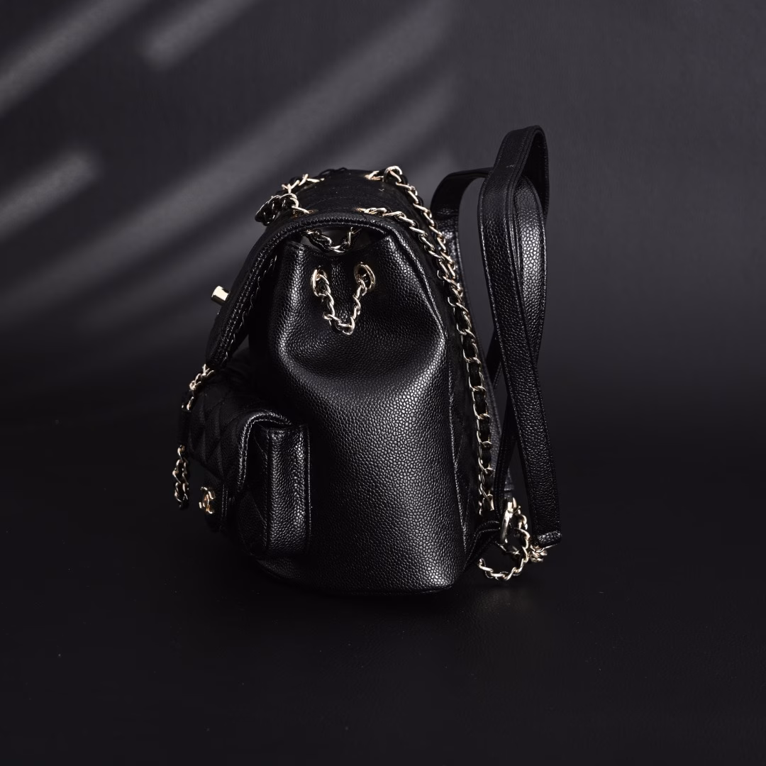 Chanel Duma 24A Retro Light Gold Buckle Diamond PatternLychee Pattern Cowhide - Backpack Medium - Unisex Couple Style Black! I fell in love with this bag at first sight! I love this luxury and low-key, fashionable and practical. In every detail, it reveals a unique artistic charm and design concept. At first glance, the design of this backpack is simple and atmospheric, but unique design elements are injected into every corner, which makes people stop and appreciate it. …Its capacity is large enough to hold, but it will not look bulky, so that you can meet your daily needs while pursuing fashion. Whether it is work or leisure, this backpack can make you cope with it easily. It is not only a bag, but also your fashion label. It can perfectly set off your temperament and make you shine in any occasion. Owning this backpack is like having a secret weapon that can make you shine in any occasion.