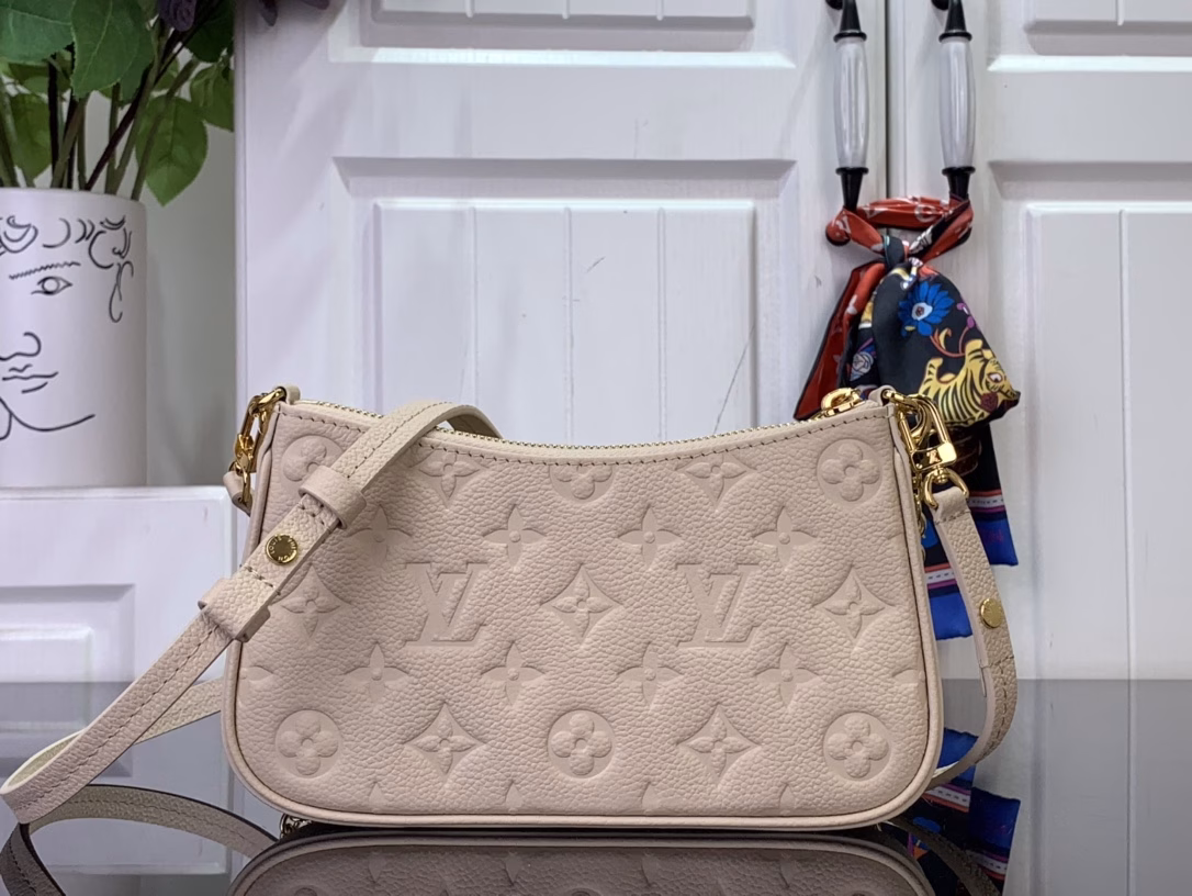 No less famous than the Easy Pouch, it's a versatile choice for both day and night. It's made from leather, embossed with the house's signature monogram, and features sleek gold hardware, including a functional D-ring. The compact design is perfectly sized for everyday essentials and offers multiple carrying options thanks to the detachable strap and chain