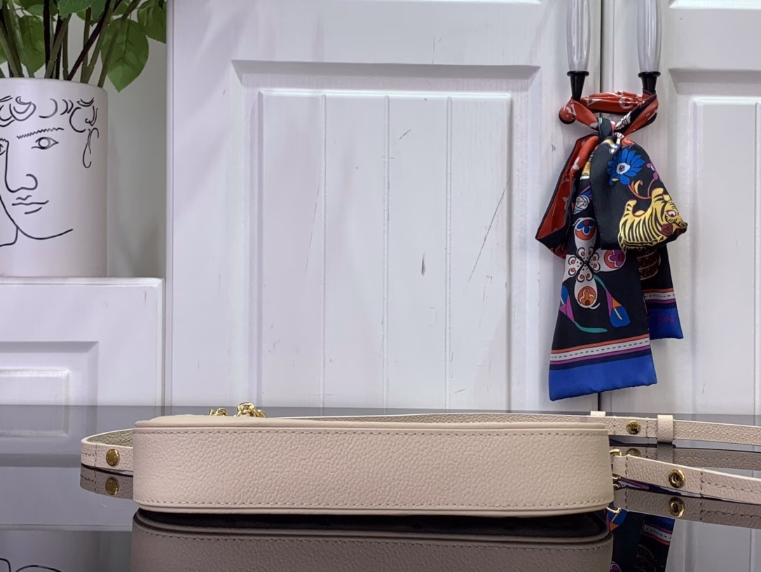 No less famous than the Easy Pouch, it's a versatile choice for both day and night. It's made from leather, embossed with the house's signature monogram, and features sleek gold hardware, including a functional D-ring. The compact design is perfectly sized for everyday essentials and offers multiple carrying options thanks to the detachable strap and chain