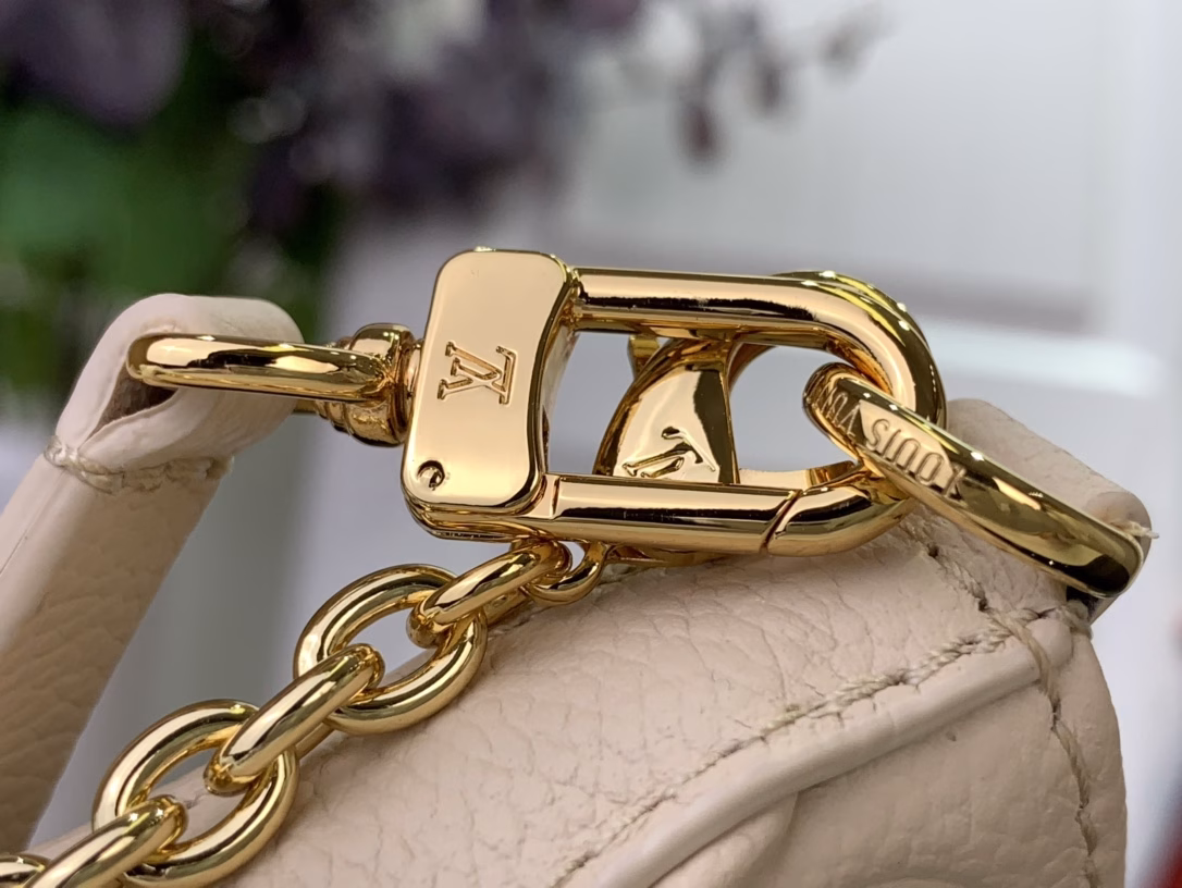 No less famous than the Easy Pouch, it's a versatile choice for both day and night. It's made from leather, embossed with the house's signature monogram, and features sleek gold hardware, including a functional D-ring. The compact design is perfectly sized for everyday essentials and offers multiple carrying options thanks to the detachable strap and chain