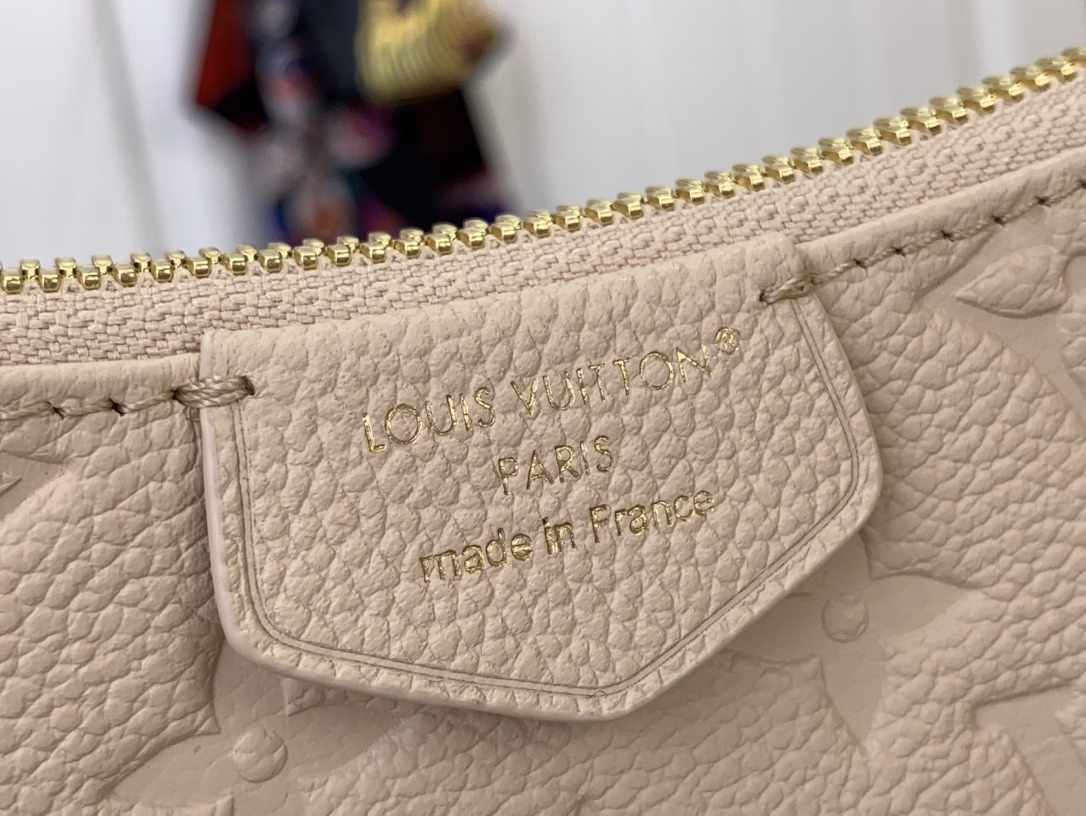 No less famous than the Easy Pouch, it's a versatile choice for both day and night. It's made from leather, embossed with the house's signature monogram, and features sleek gold hardware, including a functional D-ring. The compact design is perfectly sized for everyday essentials and offers multiple carrying options thanks to the detachable strap and chain