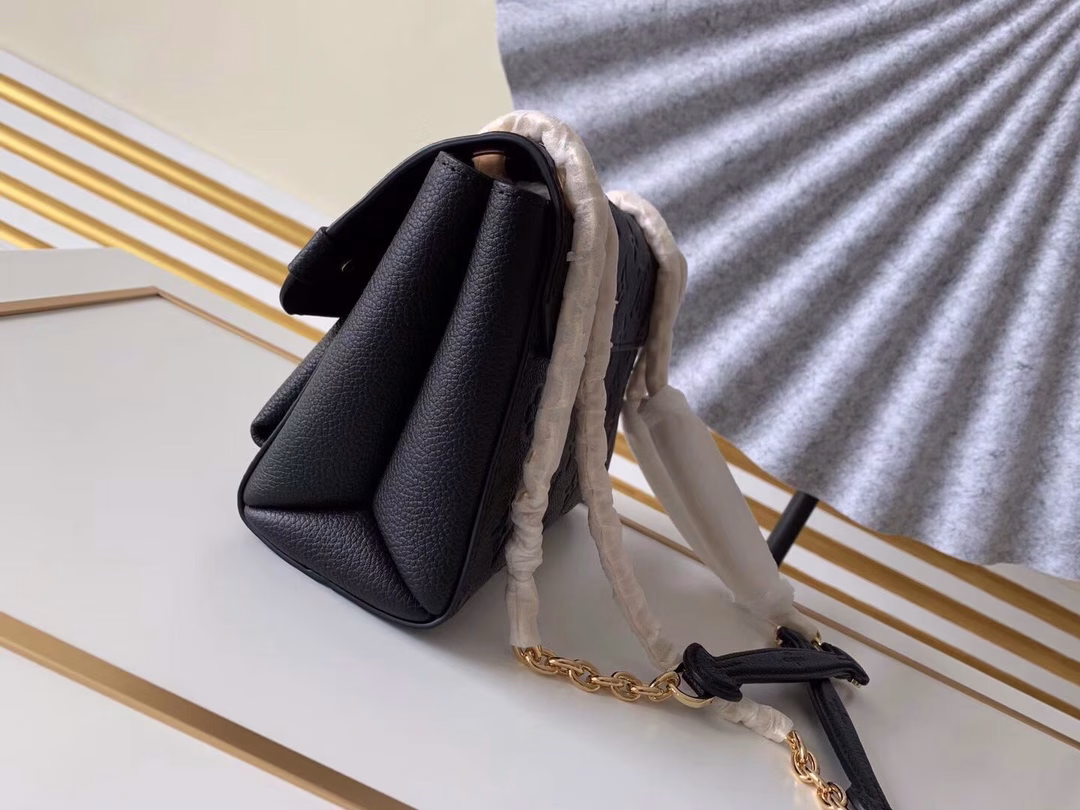 Made from a mix of smooth and embossed Monogram Empreinte leather, this small Vavin bag features a shiny, eye-catching lock design. Soft and lightweight, stylish and casual, an easy choice for everyday carry. With an adjustable leather chain strap, it can be carried on the shoulder or across the body.