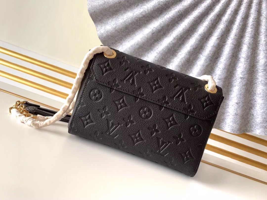 Made from a mix of smooth and embossed Monogram Empreinte leather, this small Vavin bag features a shiny, eye-catching lock design. Soft and lightweight, stylish and casual, an easy choice for everyday carry. With an adjustable leather chain strap, it can be carried on the shoulder or across the body.