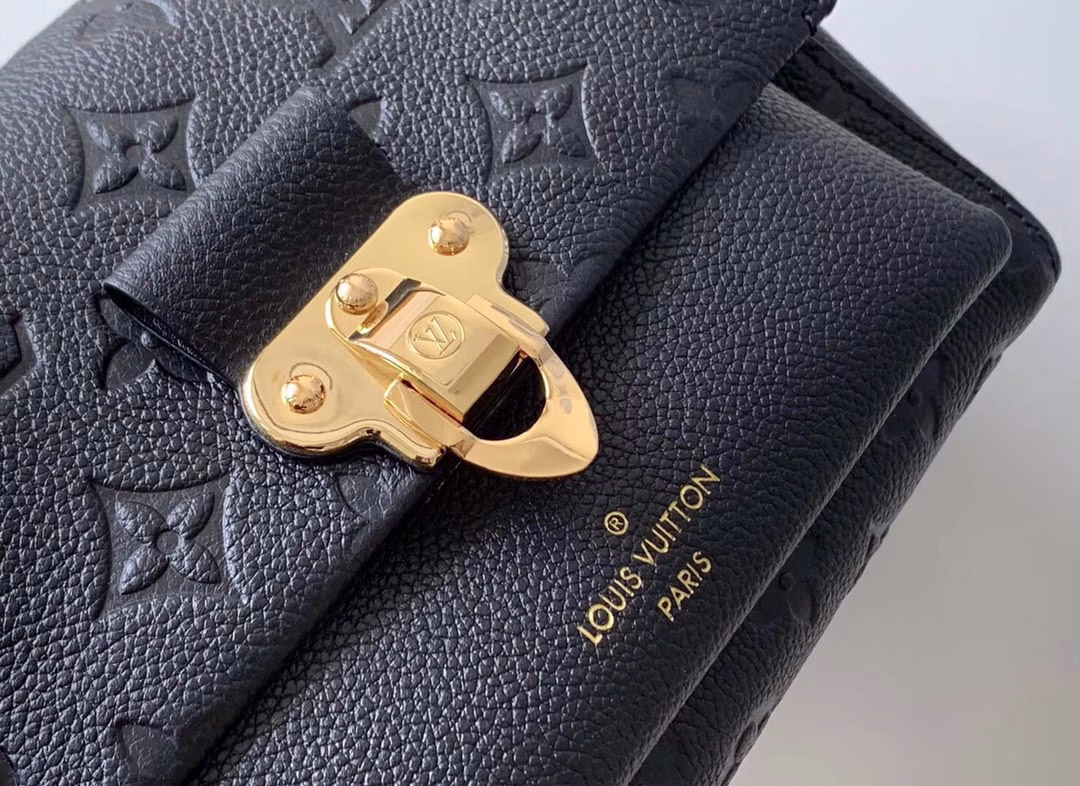 Made from a mix of smooth and embossed Monogram Empreinte leather, this small Vavin bag features a shiny, eye-catching lock design. Soft and lightweight, stylish and casual, an easy choice for everyday carry. With an adjustable leather chain strap, it can be carried on the shoulder or across the body.