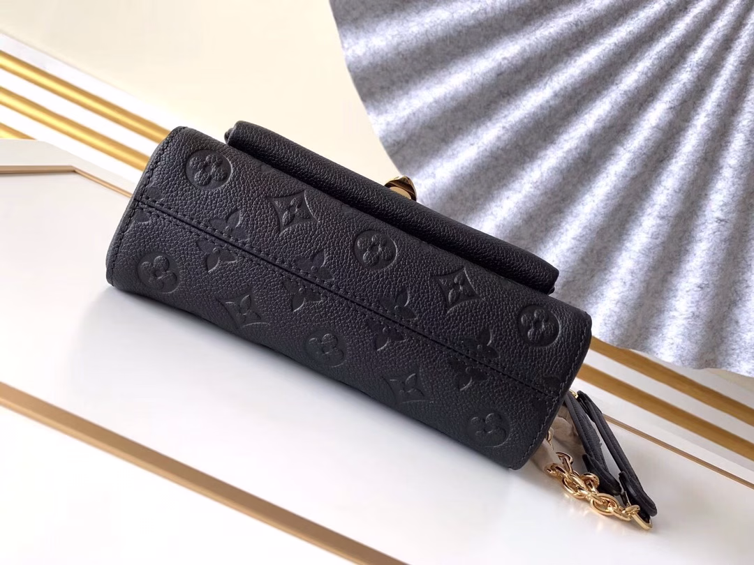 Made from a mix of smooth and embossed Monogram Empreinte leather, this small Vavin bag features a shiny, eye-catching lock design. Soft and lightweight, stylish and casual, an easy choice for everyday carry. With an adjustable leather chain strap, it can be carried on the shoulder or across the body.