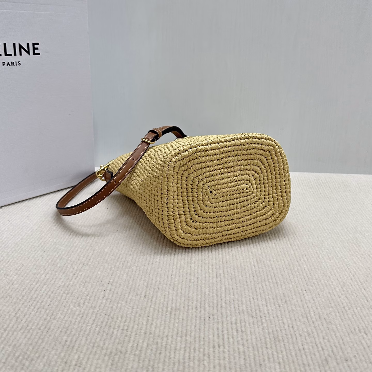 LOUISE Mini Bucket BagMini bag, this model can fit larger smartphones such as PLUSVegetable materialUnlinedGold finishHand, shoulder and crossbodyLeather flap with TRIOMPHE magnetic clasp