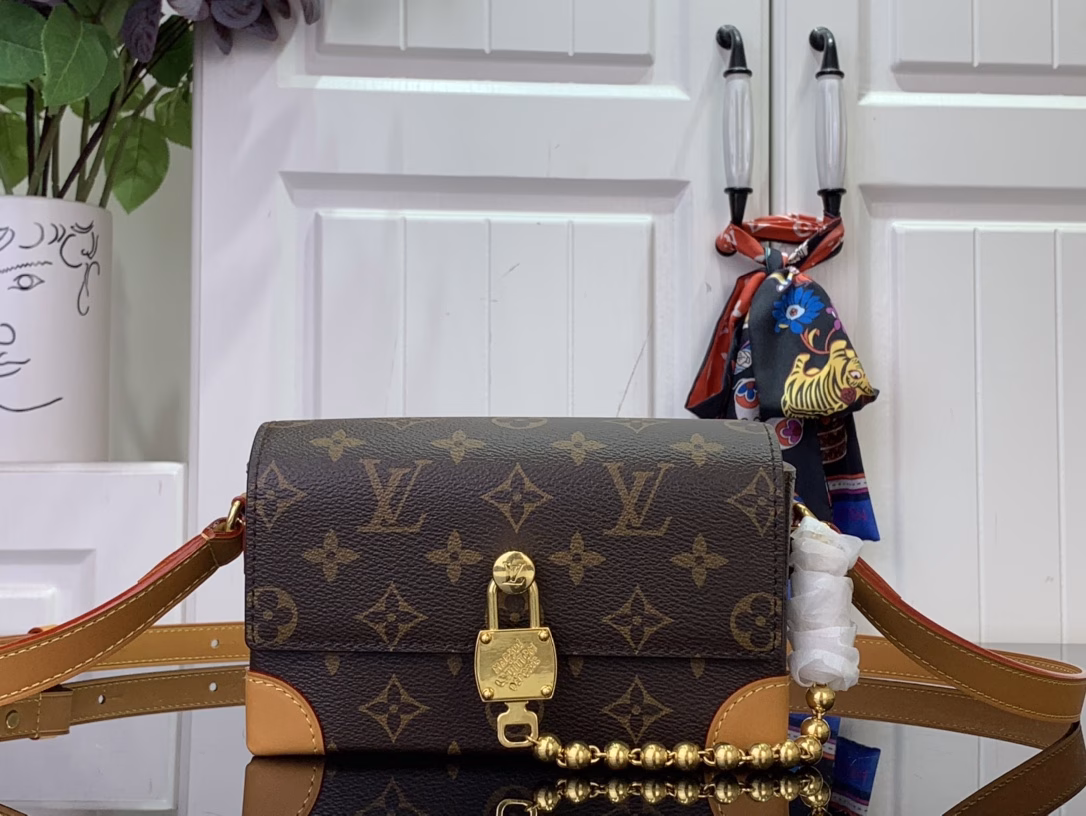 The Steamer Mini Bag is crafted from Monogram canvas with distressed calfskin trim and striking hardware. The new square lock recalls Pharrell Williams' signature Damier motif, the delicate key connects to the delicate bead chain, and the adjustable strap allows for shoulder and crossbody wear.