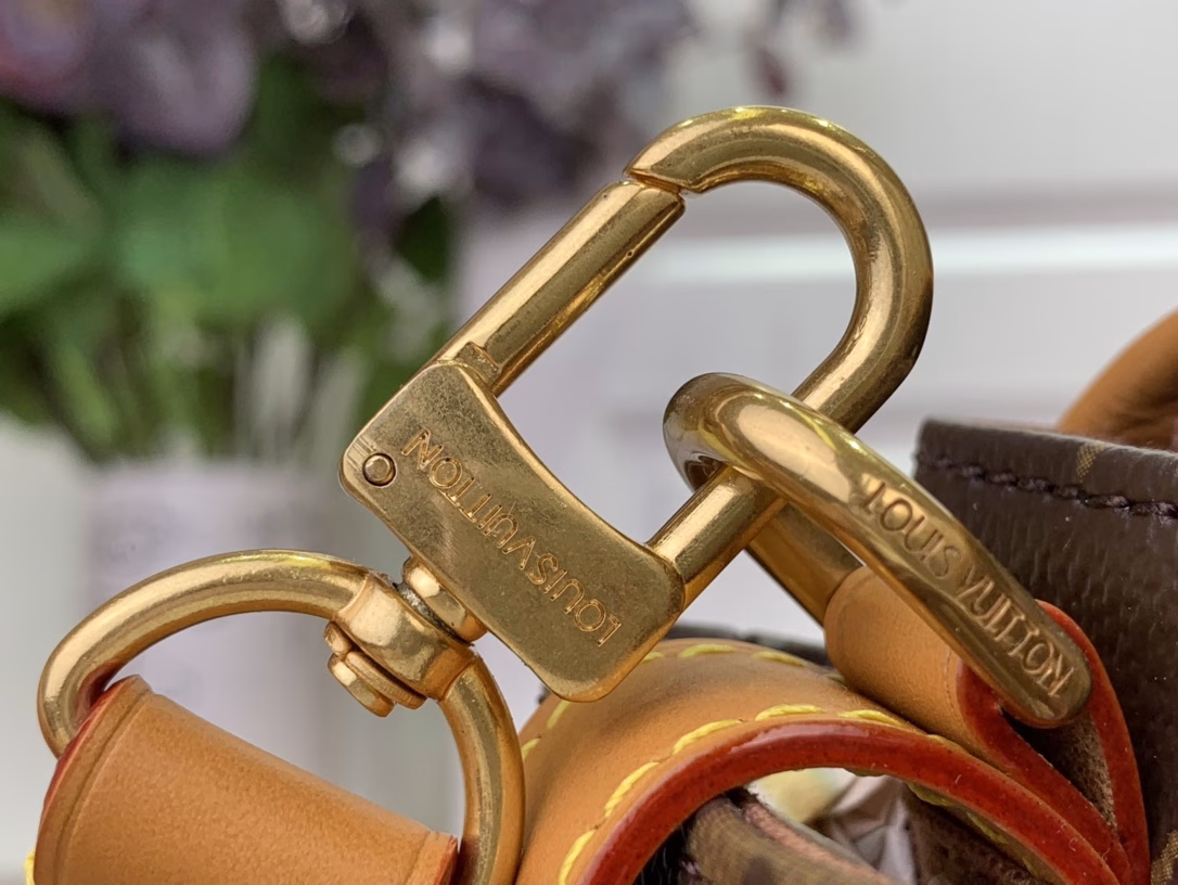 The Steamer Mini Bag is crafted from Monogram canvas with distressed calfskin trim and striking hardware. The new square lock recalls Pharrell Williams' signature Damier motif, the delicate key connects to the delicate bead chain, and the adjustable strap allows for shoulder and crossbody wear.