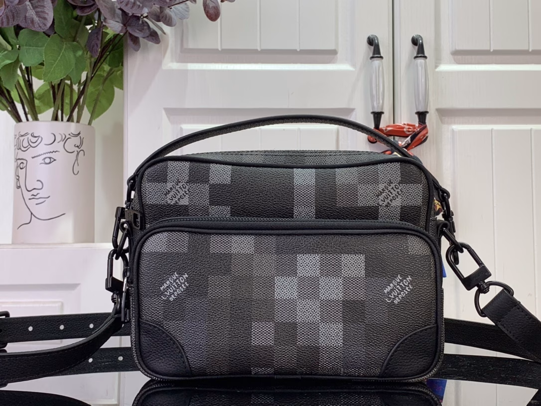 The Nil messenger bag is made from Pharrell Williams's reinterpretation of Damoflage Black coated canvas, combining the designer's fresh perspective with the brand's heritage to create a camouflage-like pixelated Damier pattern. A zip front pocket and main compartment complete the functional configuration.