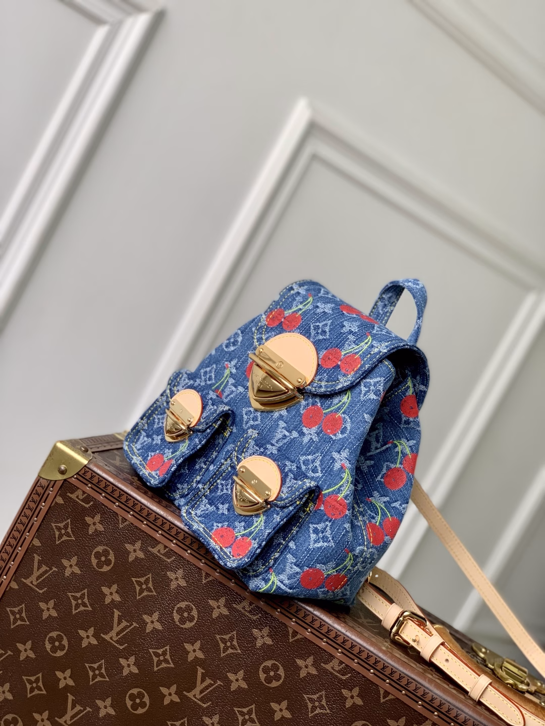This playful re-interpretation of the Louis Vuitton x Murakami Venice backpack is a joyful addition to the collection. Made from Monogram denim, the backpack features a unique embroidered cherry pattern inspired by the colorful aesthetic of Japanese artist Takashi Murakami. The slim shoulder straps are trimmed with striking natural cowhide, while the flap and two exterior patch pockets feature oversized gold-tone latches.