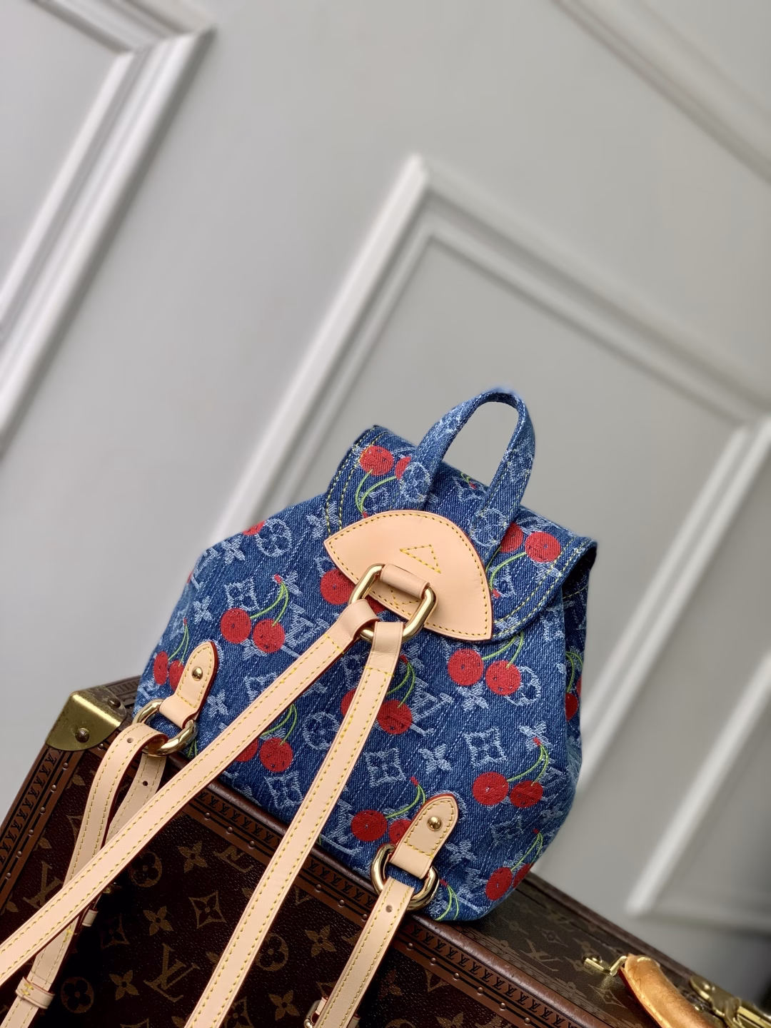 This playful re-interpretation of the Louis Vuitton x Murakami Venice backpack is a joyful addition to the collection. Made from Monogram denim, the backpack features a unique embroidered cherry pattern inspired by the colorful aesthetic of Japanese artist Takashi Murakami. The slim shoulder straps are trimmed with striking natural cowhide, while the flap and two exterior patch pockets feature oversized gold-tone latches.