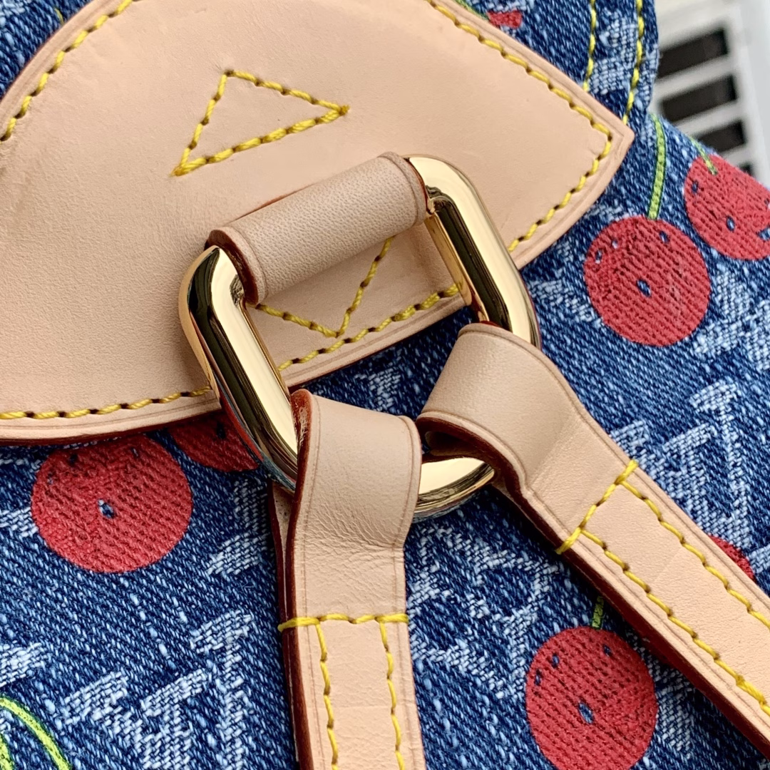 This playful re-interpretation of the Louis Vuitton x Murakami Venice backpack is a joyful addition to the collection. Made from Monogram denim, the backpack features a unique embroidered cherry pattern inspired by the colorful aesthetic of Japanese artist Takashi Murakami. The slim shoulder straps are trimmed with striking natural cowhide, while the flap and two exterior patch pockets feature oversized gold-tone latches.