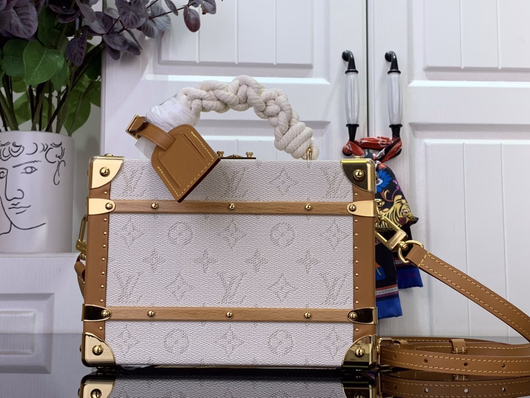 Crafted in soft Monogram Heritage canvas with calfskin trim, this Handle Trunk bag features rope handles that evoke the ropes of a ship. Its twill lining features a striped pattern, lending it a nautical feel and sophisticated detail that complements the ready-to-wear shirts from the same collection.