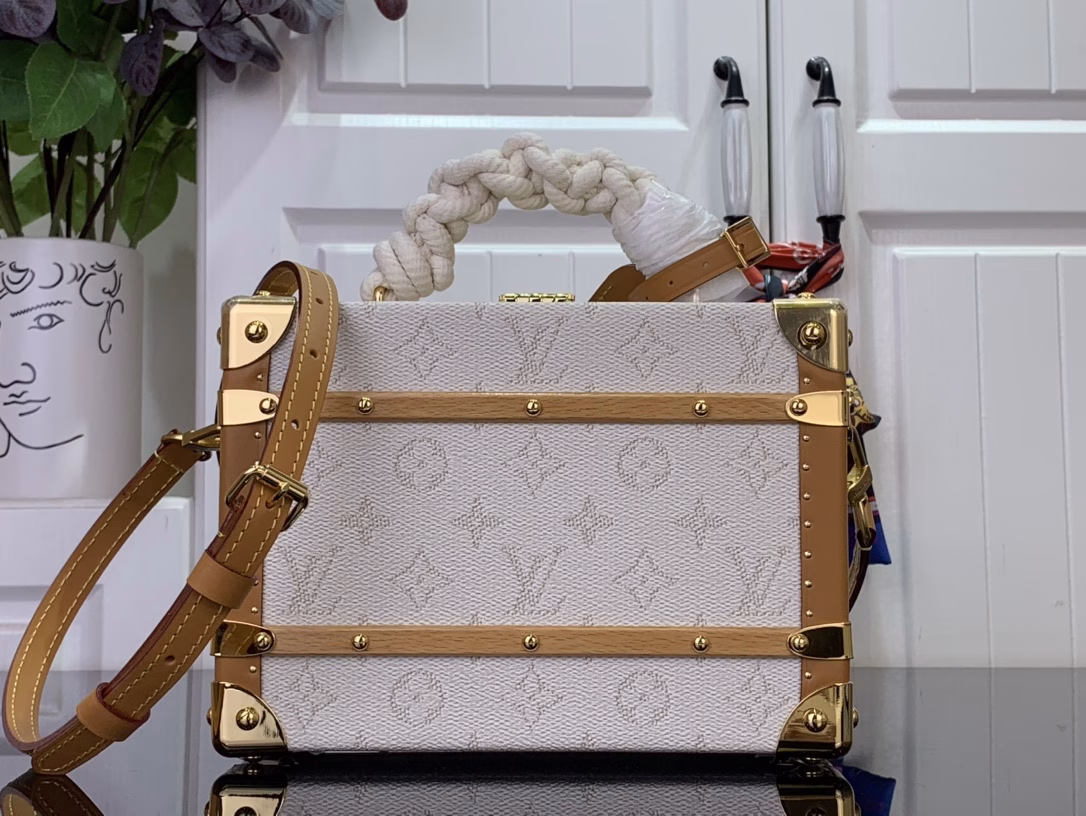 Crafted in soft Monogram Heritage canvas with calfskin trim, this Handle Trunk bag features rope handles that evoke the ropes of a ship. Its twill lining features a striped pattern, lending it a nautical feel and sophisticated detail that complements the ready-to-wear shirts from the same collection.