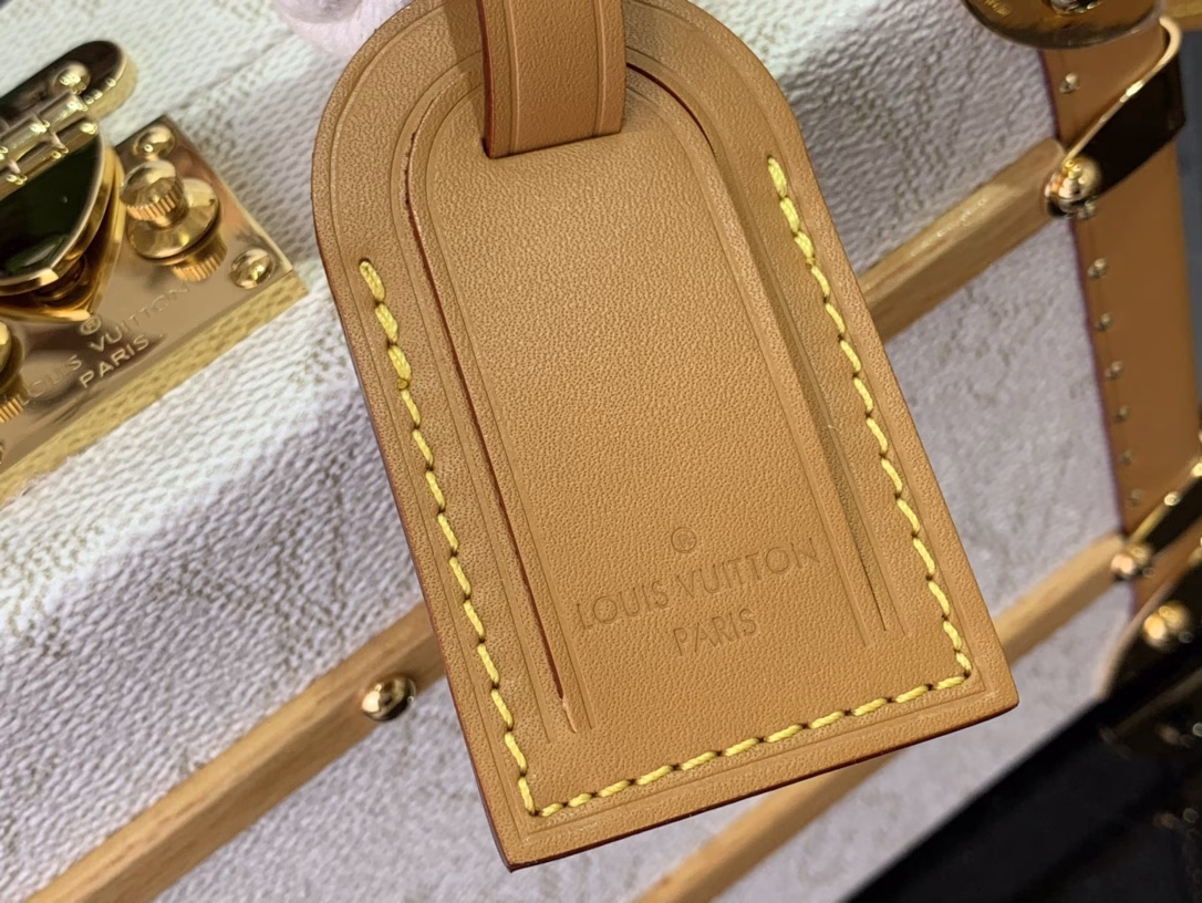 Crafted in soft Monogram Heritage canvas with calfskin trim, this Handle Trunk bag features rope handles that evoke the ropes of a ship. Its twill lining features a striped pattern, lending it a nautical feel and sophisticated detail that complements the ready-to-wear shirts from the same collection.