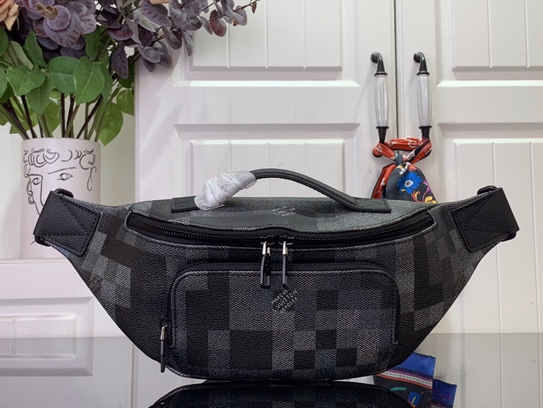 The Rush waist bag is crafted in Damoflage Black canvas with a pixelated Damier graphic overlaid for a camouflage effect. The adjustable strap allows for comfortable waist, shoulder or crossbody wear.