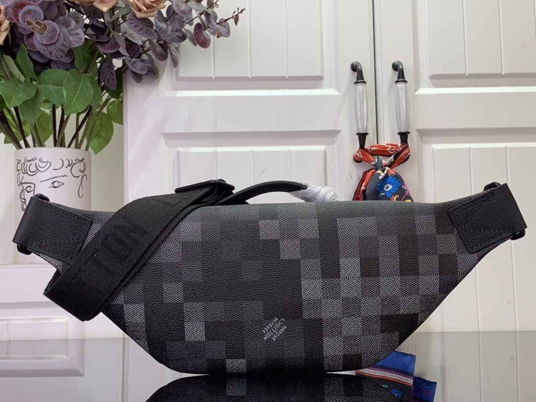 The Rush waist bag is crafted in Damoflage Black canvas with a pixelated Damier graphic overlaid for a camouflage effect. The adjustable strap allows for comfortable waist, shoulder or crossbody wear.