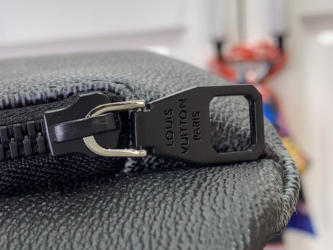 The Rush waist bag is crafted in Damoflage Black canvas with a pixelated Damier graphic overlaid for a camouflage effect. The adjustable strap allows for comfortable waist, shoulder or crossbody wear.