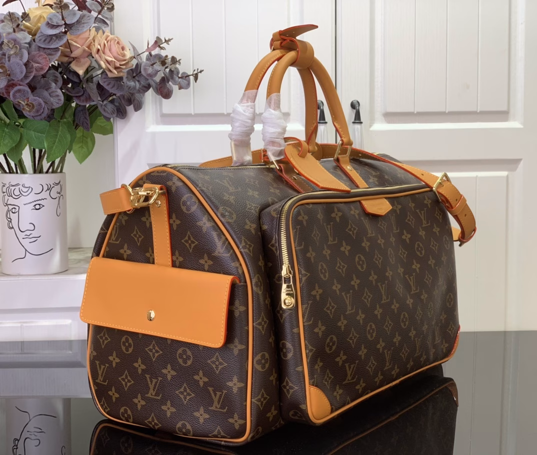 The Keepall Cargo 50 is a modern nod to the House's iconic design from the Monogram Archive collection. Made from Monogram coated canvas, it features distressed calfskin trims and striking hardware, while the main compartment and front pocket zipper pulls are embellished with metallic beads, a nod to Pharrell Williams's latest twist.