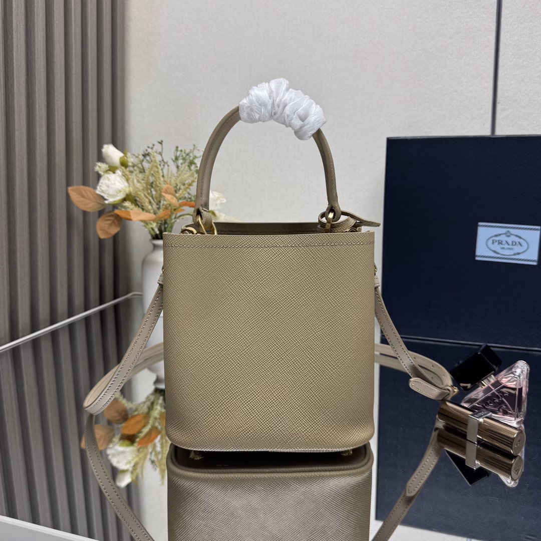 Saffiano leather Leather handles Detachable and adjustable leather shoulder strap Detachable leather name tag with metal logo Leather-covered center opening with magnetic closure Saffiano leather triangle logo Contrast nappa leather lining