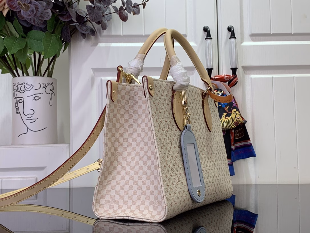 Part of the LV Romance collection, the OnTheGo PM is a unique combination of the brand's iconic Daumier and tag names, adding a splash of colour to the season. Crafted from calfskin, this elegant handbag features a playful luggage tag charm and includes a mirror, ideal for applying make-up. Attach the longer strap to wear it on your body.