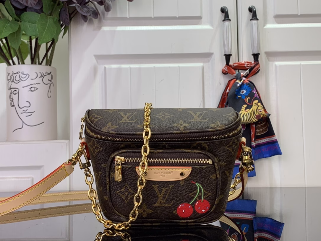 Louis Vuitton x Murakami's vibrant signature reprint elevates the Mini Bumbag with a chic twist, while a sweet cherry motif elevates the iconic Monogram coated canvas with a joyful splash of color. The on-trend silhouette features a zippered main compartment and a Louis Vuitton leather label on the front pocket. The bag can be worn on the shoulder or crossbody thanks to the removable chain and detachable and adjustable shoulder strap.