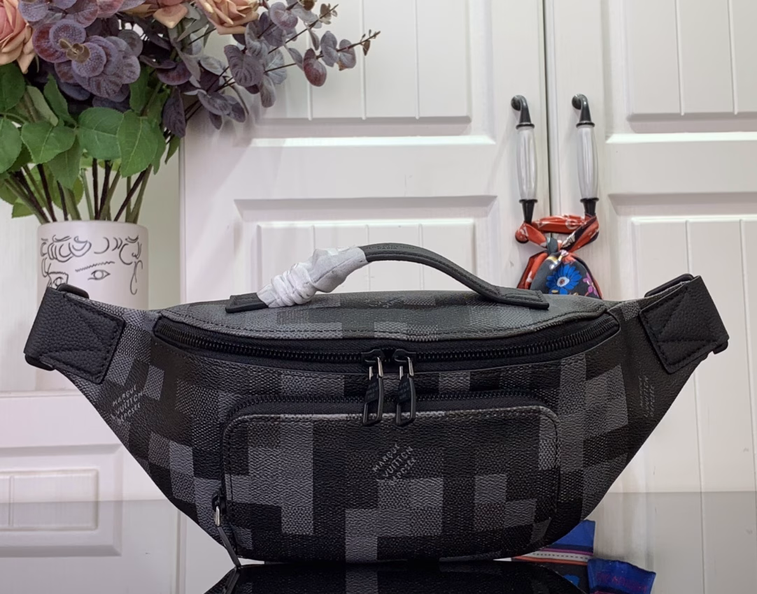 The Rush waist bag is crafted in Damoflage Black canvas with a pixelated Damier graphic overlaid for a camouflage effect. The adjustable strap allows for comfortable waist, shoulder or crossbody wear.