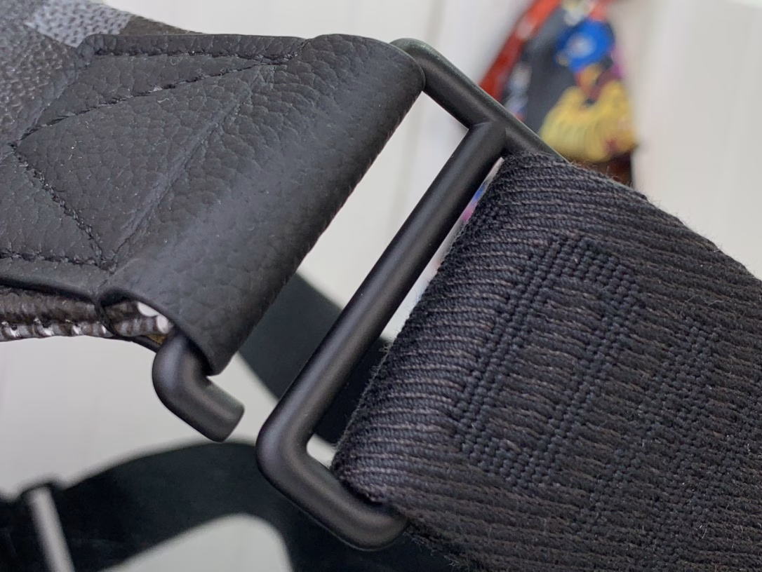 The Rush waist bag is crafted in Damoflage Black canvas with a pixelated Damier graphic overlaid for a camouflage effect. The adjustable strap allows for comfortable waist, shoulder or crossbody wear.