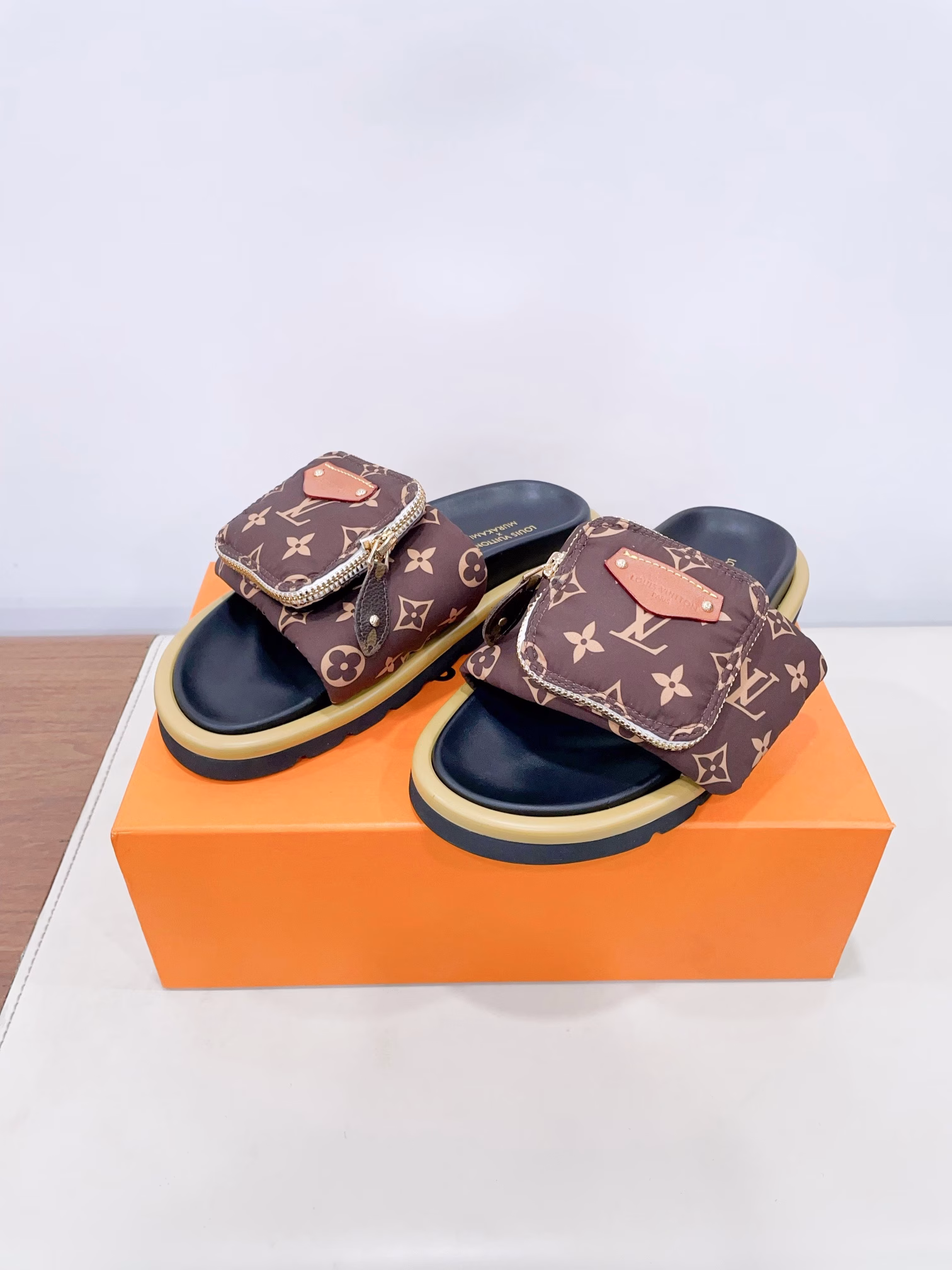 Louis Vuitto* x TM Takashi Murakami collaboration Black and White tri-color Velcro Wallet Bread Flat SlippersThe original purchased, developed and produced Pool Pillow Comfort flip-flop is from the cross-border collaboration series with Japanese artist Takashi Murakami. It features bright Monogram patterns highlighting the artist's signature vibrant colors. The wide Velcro LACES with a zipper pocket exude a striking personality, while the resilient insole and lightweight textured outsole provide a comfortable experienceDelivery counter beautifully packaged 🛍📦