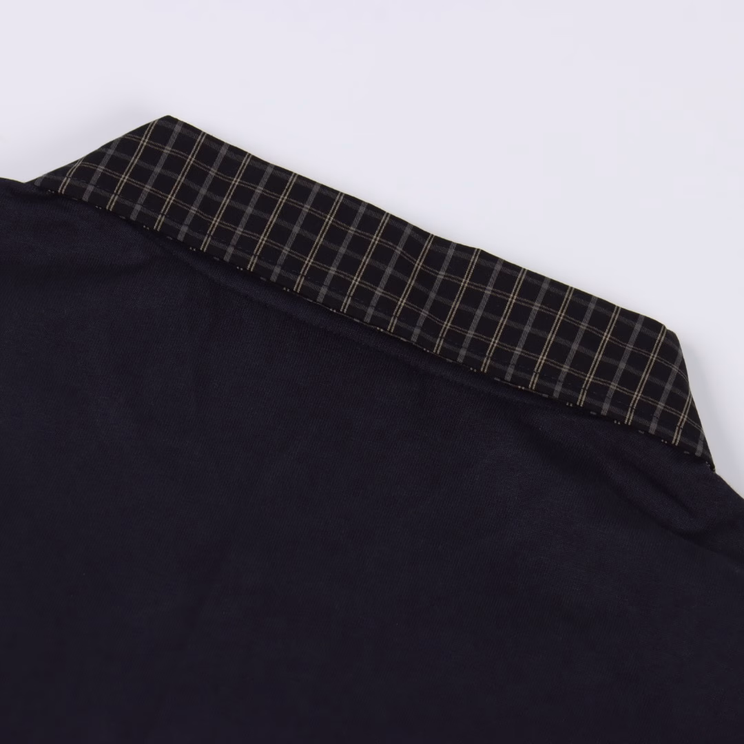 Balenciaga plaid neck patchwork Polo T-shirtThe Deconstruction Puzzle of the Parisian Family | The New Academy Manifesto of Futurists. When the British check pattern meets the silhouette of the space capsule, this Polo shirt becomes a rift in time and space in Demna's hand. Pure cotton is laid out with a deep blue texture to lay the foundation of the future, while the tear-off Scottish collar is woven with cold lines to create a retro gene - two types of warp and weft complete quantum entanglement at the sharp boundary of laser cutting. The invisible shoulder line design allows the box-shaped cut to float above the body. Two logo resin buttons, like meteorite fragments, are embedded in the chest. The collision of woven and knitted fabric reveals the playful nature of high fashion. The designer deconstructed the elite narrative of the golf club with pixel-level misalignment checkered puzzles, redefining the century-old academy symbol as an encrypted totem of the dark street aesthetics. The upper body immediately interprets high-end, the ultimate interpretation of fashion and sophistication. Unisex style, looks great when worn. Highly recommended