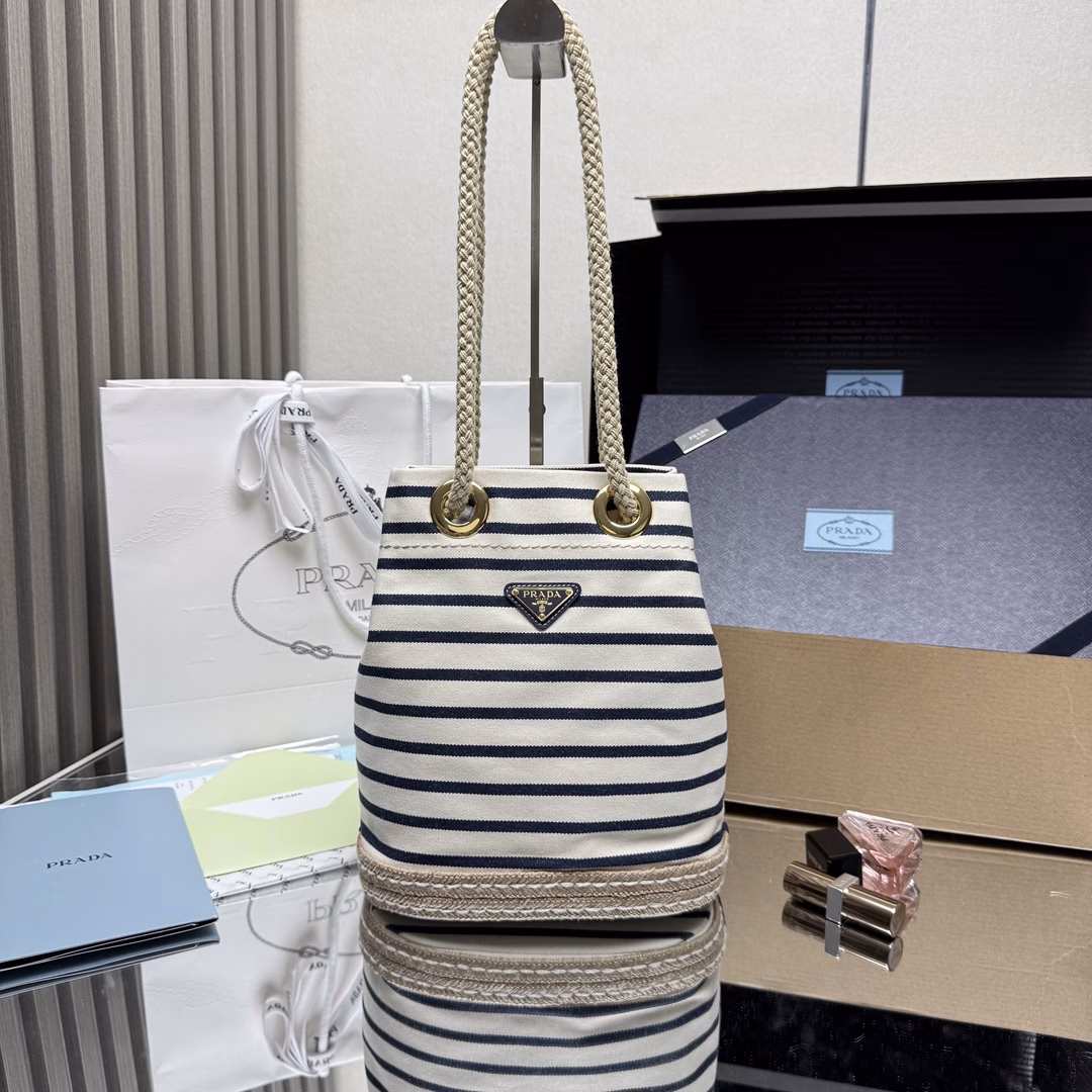 New Bucket Bag 🎉🎉 This fabric bucket bag is decorated with nautical striped patterns to add color to the look. The design inspiration of the bottom comes from straw sandals, and the rope is another detail element symbolizing the nautical world, jointly creating a strong summer atmosphere. Top-quality hardware with large capacity and space, very casual and fashionable. It's a must-have in summer and another timeless bestseller. Kids, hurry up and get it