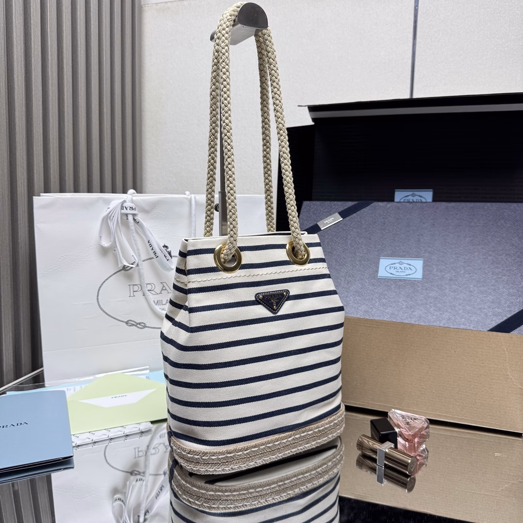 New Bucket Bag 🎉🎉 This fabric bucket bag is decorated with nautical striped patterns to add color to the look. The design inspiration of the bottom comes from straw sandals, and the rope is another detail element symbolizing the nautical world, jointly creating a strong summer atmosphere. Top-quality hardware with large capacity and space, very casual and fashionable. It's a must-have in summer and another timeless bestseller. Kids, hurry up and get it
