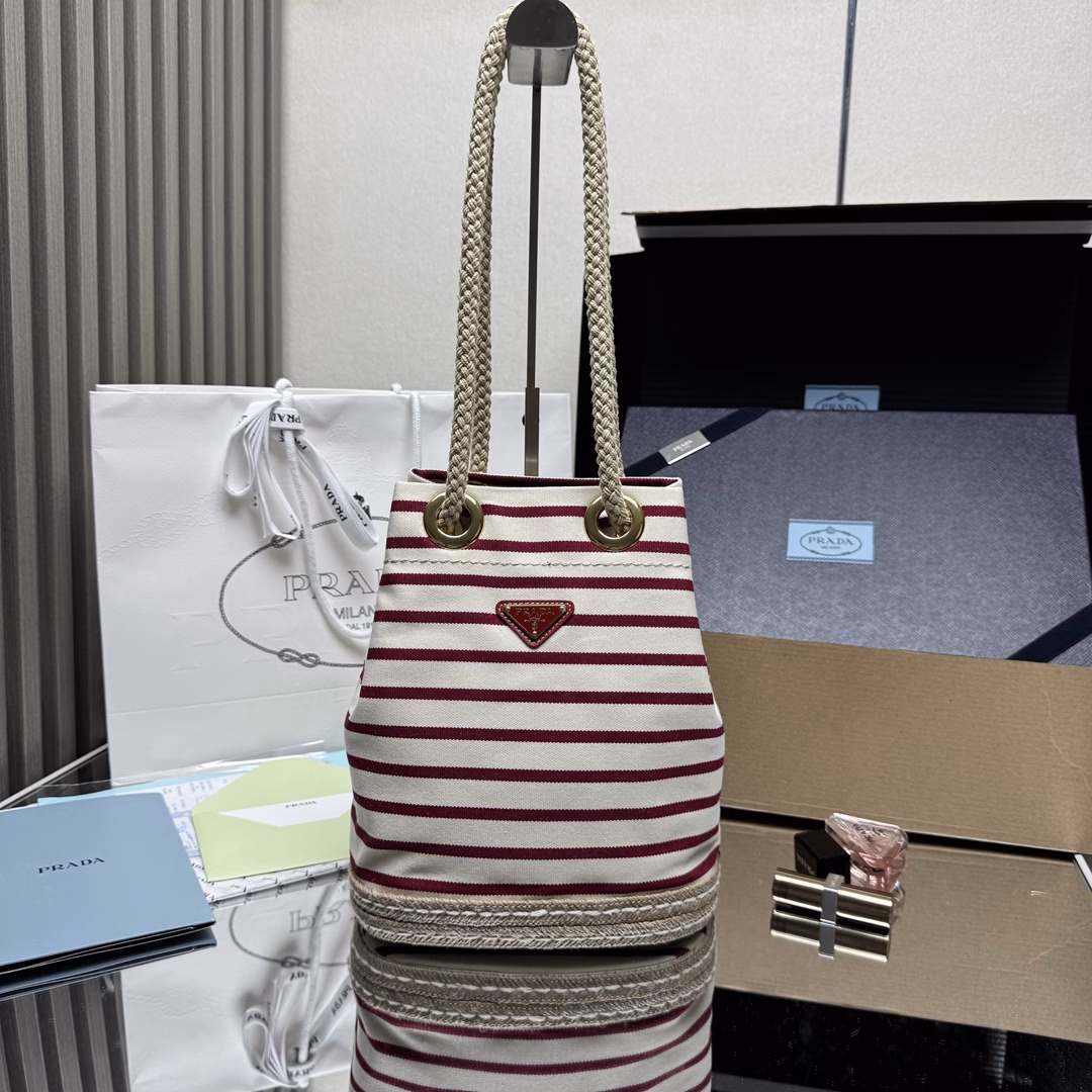 New Bucket Bag 🎉🎉 This fabric bucket bag is decorated with nautical striped patterns to add color to the look. The design inspiration of the bottom comes from straw sandals, and the rope is another detail element symbolizing the nautical world, jointly creating a strong summer atmosphere. Top-quality hardware with large capacity and space, very casual and fashionable. It's a must-have in summer and another timeless bestseller. Kids, hurry up and get it