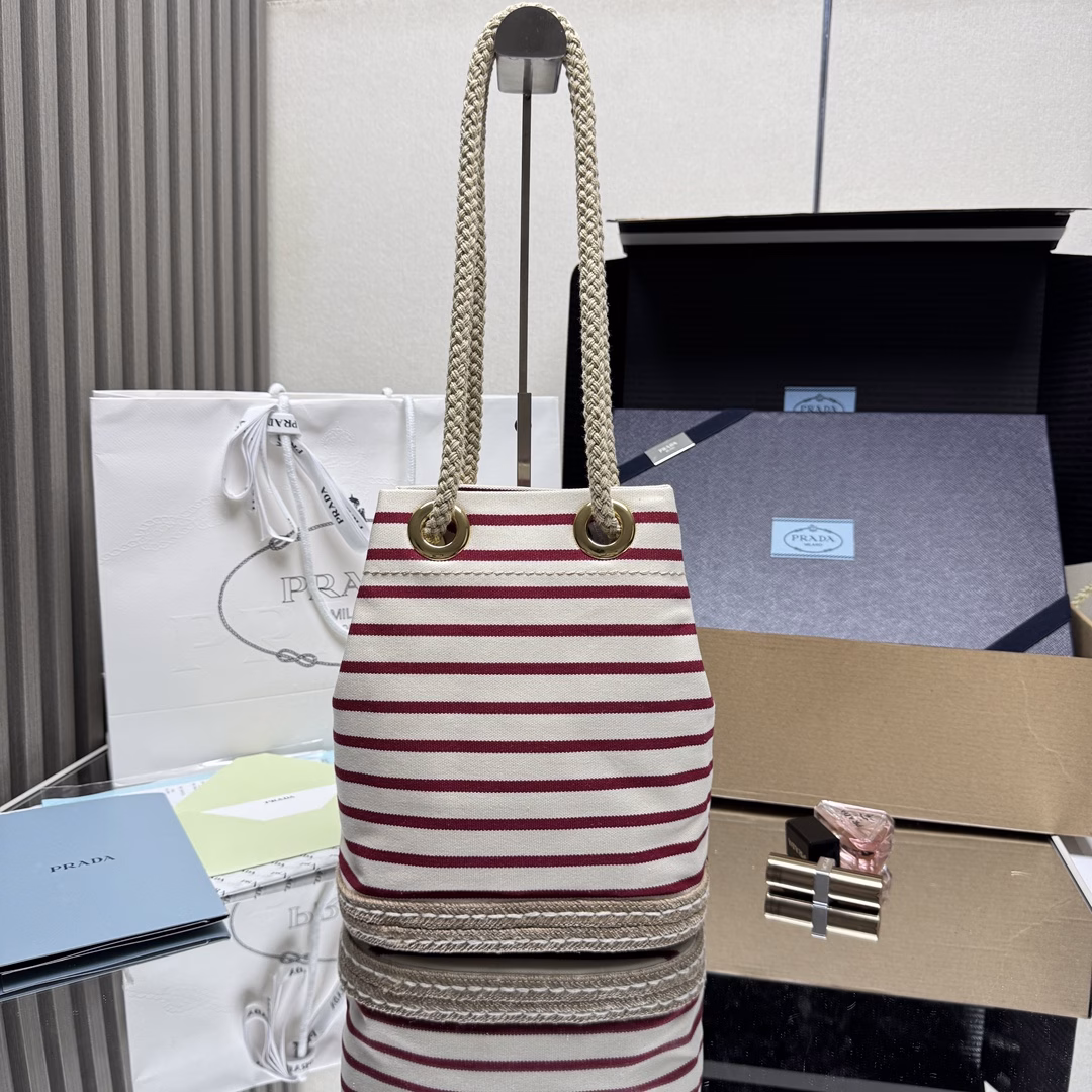 New Bucket Bag 🎉🎉 This fabric bucket bag is decorated with nautical striped patterns to add color to the look. The design inspiration of the bottom comes from straw sandals, and the rope is another detail element symbolizing the nautical world, jointly creating a strong summer atmosphere. Top-quality hardware with large capacity and space, very casual and fashionable. It's a must-have in summer and another timeless bestseller. Kids, hurry up and get it