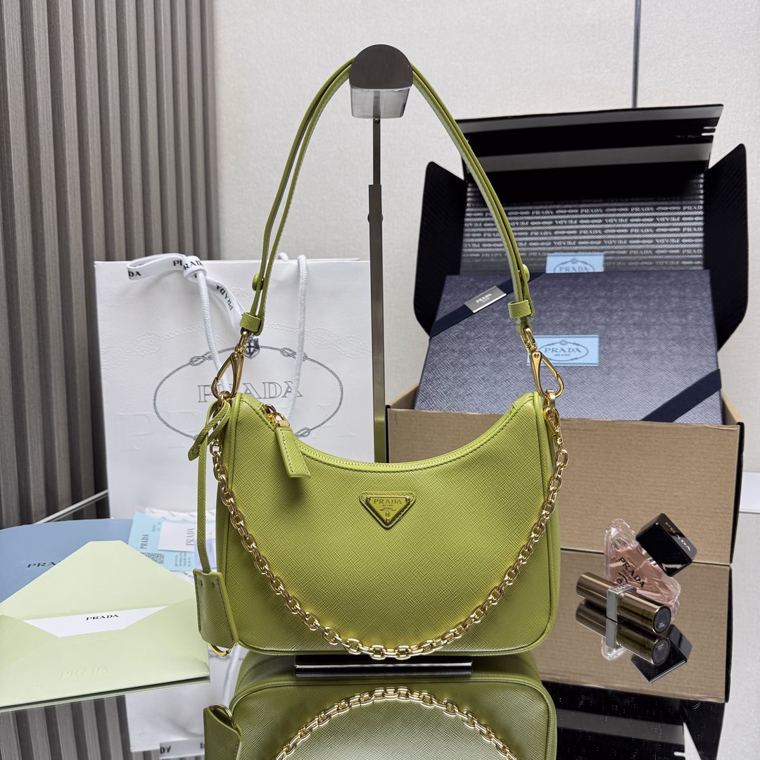 The newly upgraded Hobo🎉 strap detachable 🎉 This versatile handbag features sleek lines and classic details, paired with a detachable chain and adjustable long shoulder strap, and can be carried by hand or crossbody. It is made of Saffiano leather and adorned with a distinctive enameled triangular metal logo. Here comes another timeless bestseller. Kids, hurry up and get it