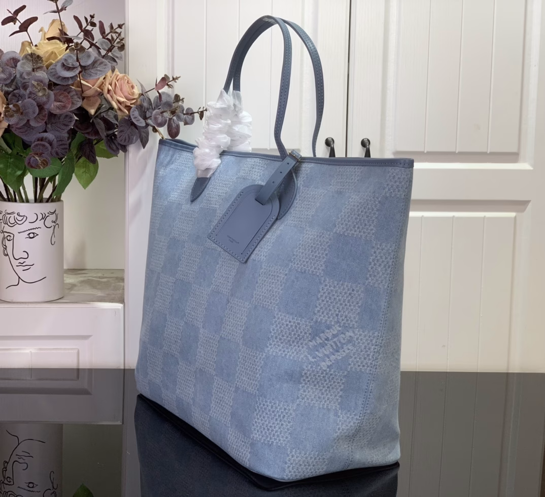 This Nevereverfull tote is crafted from Damier Denim 3D cotton canvas with a chic check pattern, finished with polished hardware and leather trims. The zip fastening allows for plenty of space, and the removable cotton denim canvas pocket provides ample storage for your belongings.