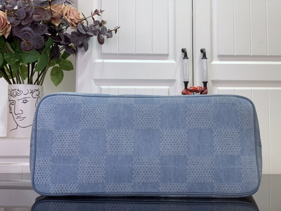 This Nevereverfull tote is crafted from Damier Denim 3D cotton canvas with a chic check pattern, finished with polished hardware and leather trims. The zip fastening allows for plenty of space, and the removable cotton denim canvas pocket provides ample storage for your belongings.