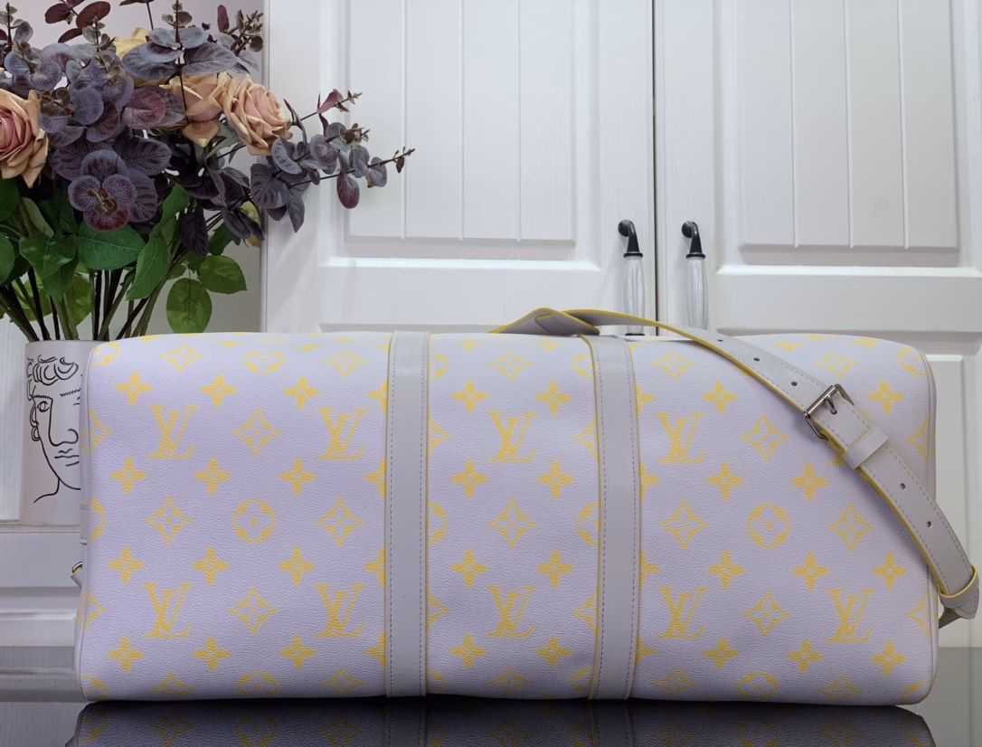 The Keepall Bandoulière 50 travel bag is crafted from colorful Monogram Glow canvas with a contrasting Monogram pattern on the fabric lining and branding. Leather side straps, top handles and a removable shoulder strap continue the color palette, while distressed hardware completes the look.