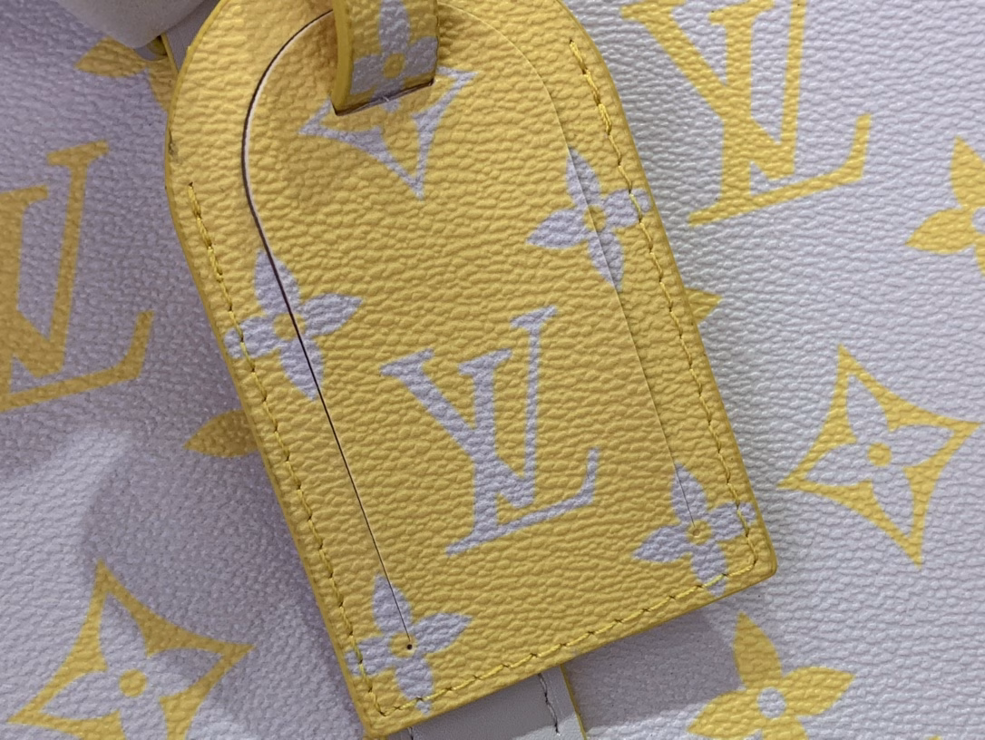 The Keepall Bandoulière 50 travel bag is crafted from colorful Monogram Glow canvas with a contrasting Monogram pattern on the fabric lining and branding. Leather side straps, top handles and a removable shoulder strap continue the color palette, while distressed hardware completes the look.