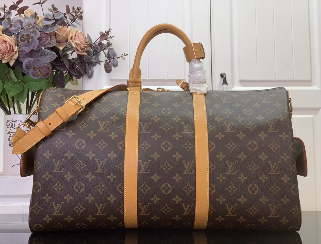 The Keepall Cargo 50 is a modern nod to the House's iconic design from the Monogram Archive collection. Made from Monogram coated canvas, it features distressed calfskin trims and striking hardware, while the main compartment and front pocket zipper pulls are embellished with metallic beads, a nod to Pharrell Williams's latest twist.