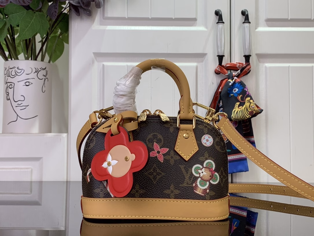 Inspired by the festive spirit of the Candy Factory collection, this Nano Alma bag features the brand's mascot, Vivienne, in a colorful pattern and leather charms that complement the vibrant lining. The Monogram canvas pays homage to the brand's heritage, creating a playful take on classic style.