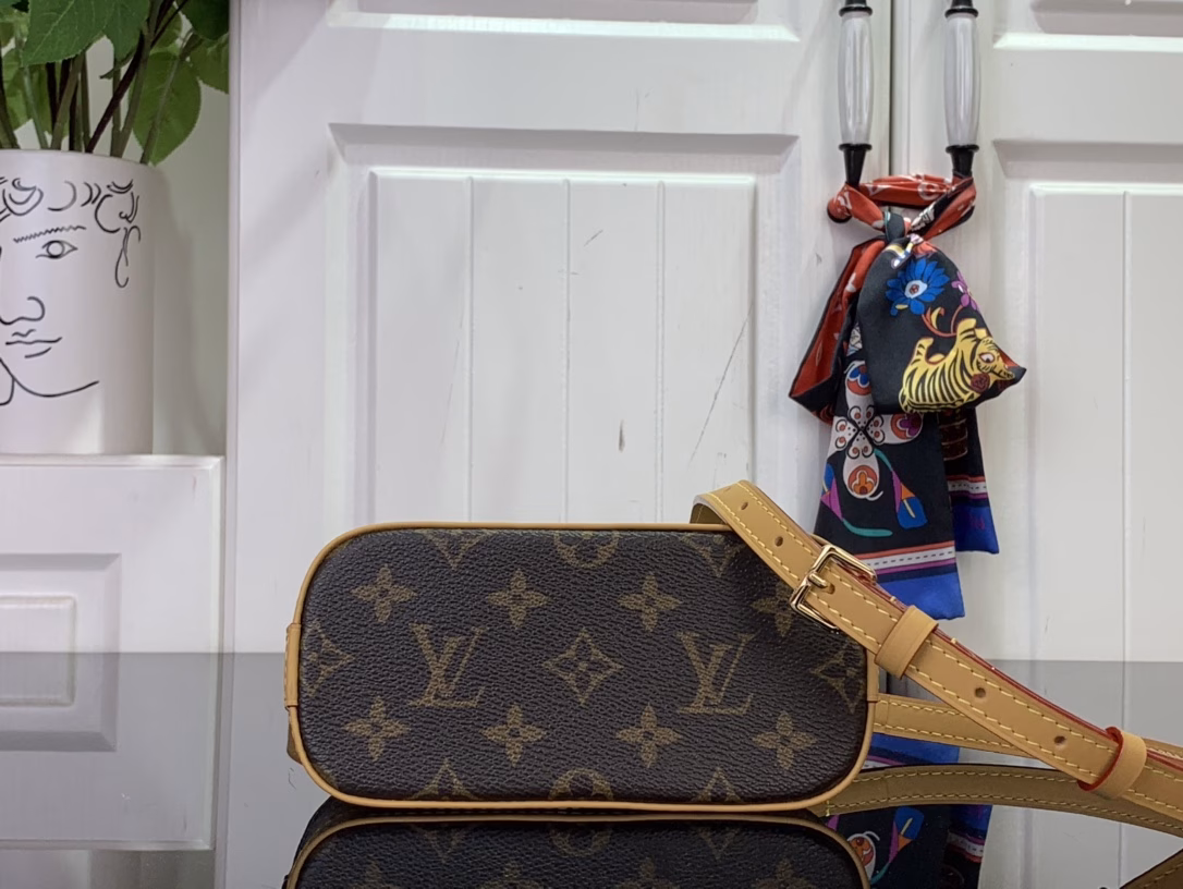 Inspired by the festive spirit of the Candy Factory collection, this Nano Alma bag features the brand's mascot, Vivienne, in a colorful pattern and leather charms that complement the vibrant lining. The Monogram canvas pays homage to the brand's heritage, creating a playful take on classic style.