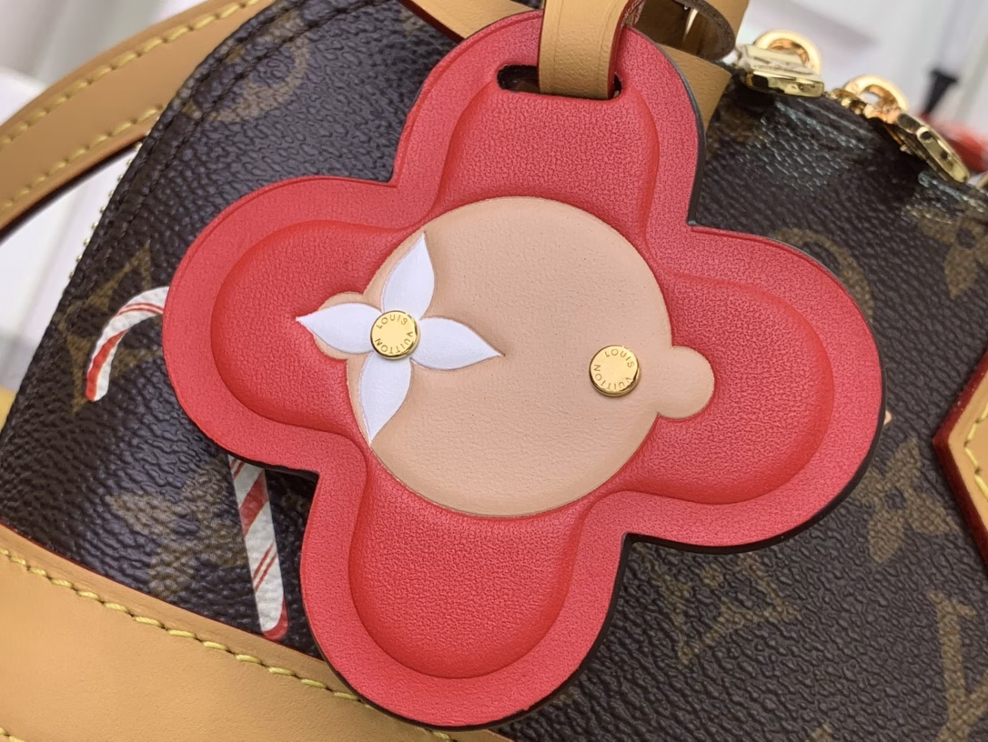 Inspired by the festive spirit of the Candy Factory collection, this Nano Alma bag features the brand's mascot, Vivienne, in a colorful pattern and leather charms that complement the vibrant lining. The Monogram canvas pays homage to the brand's heritage, creating a playful take on classic style.