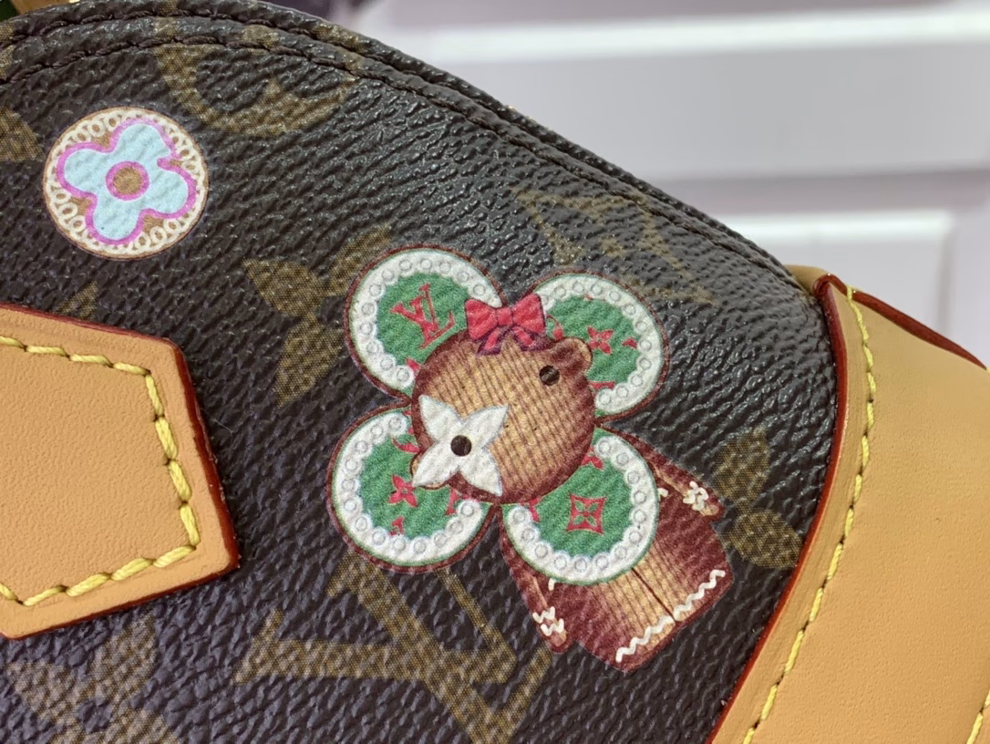 Inspired by the festive spirit of the Candy Factory collection, this Nano Alma bag features the brand's mascot, Vivienne, in a colorful pattern and leather charms that complement the vibrant lining. The Monogram canvas pays homage to the brand's heritage, creating a playful take on classic style.