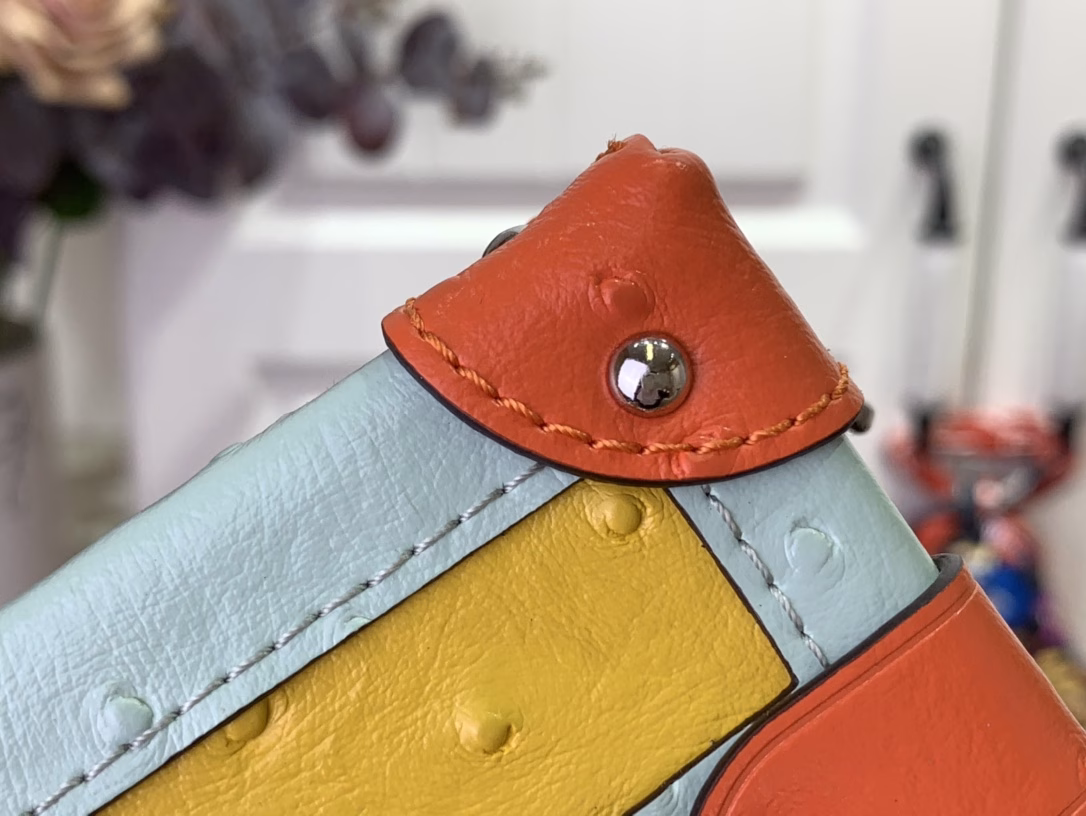 This Petite Malle bag is from the Monogram Wet collection and features a Monogram pattern on soft calfskin leather. The removable metal chain incorporates Gothic Monogram floral elements, and the top handle and removable and adjustable leather shoulder strap allow for multiple carrying options.